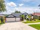 Charming single-story home boasting a well-manicured lawn, lush landscaping, and a spacious three-car garage at 533 Quail Down Dr, Debary, FL 32713