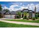 Charming home with lush landscaping, lawn and a three-car garage at 533 Quail Down Dr, Debary, FL 32713