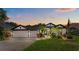 Charming home with a well-manicured lawn, lush landscaping, and a three-car garage at 533 Quail Down Dr, Debary, FL 32713