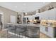 Bright eat-in kitchen featuring white cabinetry, stainless steel appliances, and a stylish breakfast bar with seating at 533 Quail Down Dr, Debary, FL 32713