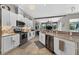 Stylish kitchen featuring granite counters, white cabinetry, stainless steel appliances, and seamless flow into a living space at 533 Quail Down Dr, Debary, FL 32713