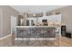 Bright eat-in kitchen featuring white cabinetry, stainless steel appliances, and a stylish breakfast bar with seating at 533 Quail Down Dr, Debary, FL 32713