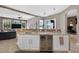 Stylish kitchen bar featuring granite counters, a wine fridge, and seamless flow into a living space at 533 Quail Down Dr, Debary, FL 32713