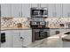 Modern kitchen featuring stainless steel appliances, granite countertops, and white cabinetry at 533 Quail Down Dr, Debary, FL 32713