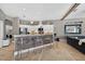 Spacious kitchen featuring a large island with seating, stainless appliances and an adjacent living space at 533 Quail Down Dr, Debary, FL 32713