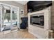 Living room featuring a modern fireplace and luxury chairs with a view of the pool at 533 Quail Down Dr, Debary, FL 32713