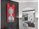 Stylish living area with a unique artwork feature wall and clear modern chairs at 533 Quail Down Dr, Debary, FL 32713