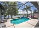 Relaxing screened-in pool area overlooking a serene lake at 533 Quail Down Dr, Debary, FL 32713