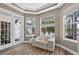 Relax in this sun room featuring wood floors, comfortable seating, and access to the outdoors at 533 Quail Down Dr, Debary, FL 32713