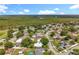 Overhead view of a community near wooded area with houses, streets, and backyard pools at 5409 Holtland Dr, Apopka, FL 32712