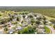 Aerial view of the neighborhood and surrounding woods with winding roads and green trees at 5409 Holtland Dr, Apopka, FL 32712