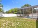 Back yard showing the screen pool area with privacy fence and sparse grass at 5409 Holtland Dr, Apopka, FL 32712