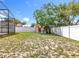 Backyard view of a shed surrounded by a white vinyl fence and sparse grass at 5409 Holtland Dr, Apopka, FL 32712
