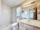 A well-lit bathroom featuring a standing shower, vanity and a mirrored cabinet at 5409 Holtland Dr, Apopka, FL 32712