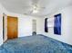 Bedroom with blue carpet, ceiling fan, one window with blue curtains, and a closet at 5409 Holtland Dr, Apopka, FL 32712
