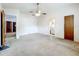 A spacious bedroom with ceiling fan, adjacent room, and a neutral color scheme at 5409 Holtland Dr, Apopka, FL 32712