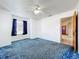 Bedroom with blue carpet, ceiling fan, one window with blue curtains, and an ensuite bathroom at 5409 Holtland Dr, Apopka, FL 32712