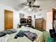 Standard bedroom features a ceiling fan, simple furnishings, and ensuite bathroom at 5409 Holtland Dr, Apopka, FL 32712