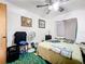 Bedroom features a ceiling fan, basic furnishings, and simple decor on the walls at 5409 Holtland Dr, Apopka, FL 32712