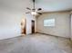Spacious bedroom featuring a ceiling fan and ensuite bathroom entrance at 5409 Holtland Dr, Apopka, FL 32712