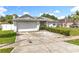 Charming single-story home with a well-maintained front yard and attached two-car garage at 5409 Holtland Dr, Apopka, FL 32712