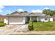Charming single-story home with a well-maintained front yard and attached two-car garage at 5409 Holtland Dr, Apopka, FL 32712