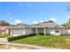Inviting single-story home featuring a lush green lawn and an attached two-car garage at 5409 Holtland Dr, Apopka, FL 32712
