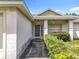 Welcoming front entrance with covered porch and manicured shrubbery providing curb appeal at 5409 Holtland Dr, Apopka, FL 32712