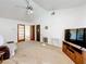 Bright living room with a TV and vaulted ceiling, offering a comfortable space at 5409 Holtland Dr, Apopka, FL 32712