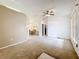 Spacious living area featuring a ceiling fan and a view into the adjacent dining space at 5409 Holtland Dr, Apopka, FL 32712