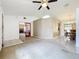 Open-concept living area connecting to the dining room, featuring neutral colors and natural light at 5409 Holtland Dr, Apopka, FL 32712