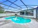 Screened pool with clear blue water and patio, near the home's enclosed sunroom at 5409 Holtland Dr, Apopka, FL 32712