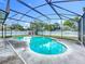 Screened pool with clear blue water and patio next to a fenced in yard at 5409 Holtland Dr, Apopka, FL 32712