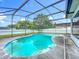 Screened pool with clear blue water and a patio with surrounding privacy fence at 5409 Holtland Dr, Apopka, FL 32712