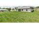 Expansive backyard showcasing the home's exterior and a lush, green lawn perfect for outdoor activities at 5908 Sw 115 Street Rd, Ocala, FL 34476