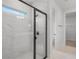 Modern bathroom featuring glass shower, white marble and tile, and a bright interior at 5908 Sw 115 Street Rd, Ocala, FL 34476