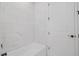 Bright bathroom featuring white marble tile surround and a soaking tub at 5908 Sw 115 Street Rd, Ocala, FL 34476