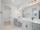 Bathroom includes dual sinks, white countertops, and a large mirror with vanity lighting at 5908 Sw 115 Street Rd, Ocala, FL 34476
