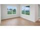 Sunlit bedroom features hard wood floors and two large windows at 5908 Sw 115 Street Rd, Ocala, FL 34476