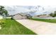 New home with long driveway and green lawn at 5908 Sw 115 Street Rd, Ocala, FL 34476