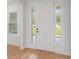 New home with elegant white door with decorative sidelights at 5908 Sw 115 Street Rd, Ocala, FL 34476