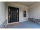 Front entryway of a new home with a dark-colored door at 5908 Sw 115 Street Rd, Ocala, FL 34476