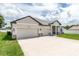 Beautiful new home with an oversized garage and manicured lawn at 5908 Sw 115 Street Rd, Ocala, FL 34476