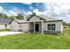 New home with a manicured lawn and an elegant front entryway at 5908 Sw 115 Street Rd, Ocala, FL 34476