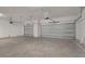 Spacious garage featuring two sectional doors with automatic openers and ample room for storage and vehicles at 5908 Sw 115 Street Rd, Ocala, FL 34476