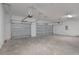 Spacious garage featuring two sectional doors with automatic openers and ample room for storage and vehicles at 5908 Sw 115 Street Rd, Ocala, FL 34476