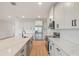 Bright kitchen features wood flooring, stainless appliances, and white countertops at 5908 Sw 115 Street Rd, Ocala, FL 34476