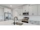 Modern kitchen with stainless steel appliances, island, and bright white cabinetry at 5908 Sw 115 Street Rd, Ocala, FL 34476