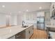 Open kitchen with island features quartz countertops, stainless appliances, and ample lighting at 5908 Sw 115 Street Rd, Ocala, FL 34476
