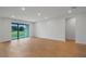 Spacious living room featuring wood floors and sliding glass doors at 5908 Sw 115 Street Rd, Ocala, FL 34476